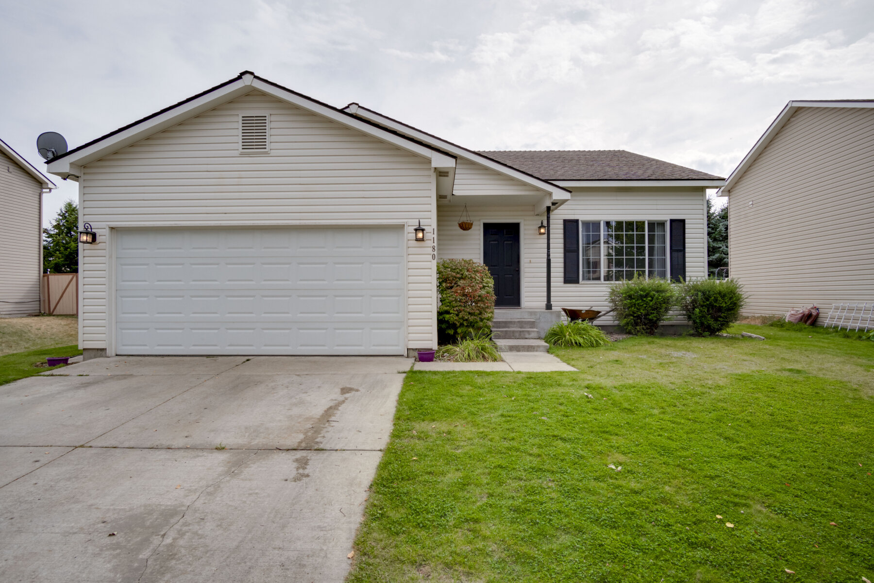  Cream colored home with lawn. 