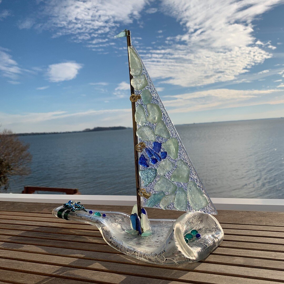 Come Sail Away With Me.... I am back after a few weeks of taking a break.  This is one of my new pieces made with river glass.  You can see my process.  First I fused blue frit on a glass sail - fired in the kiln.  Next I drilled holes and attached t