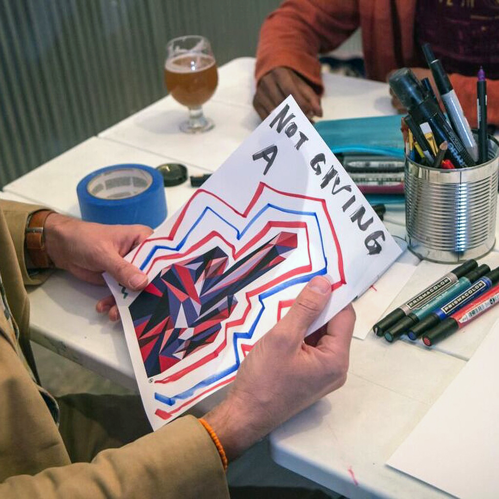  Participants write and draw on copies of an extraction of the original work, F-U-Red Blue and then share their creation by taping it to a wall. 