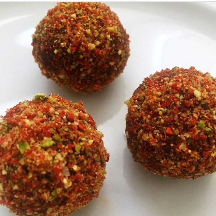 Raw cacao truffle with goji berry and pistachio dust