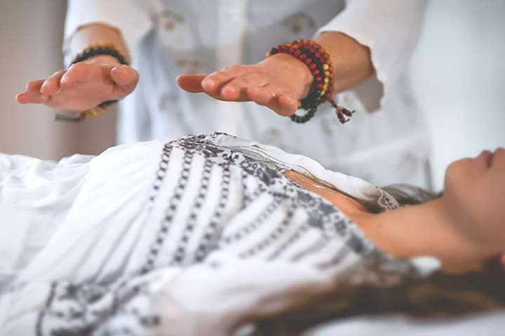 woman receiving energy healing with mala beads.jpg