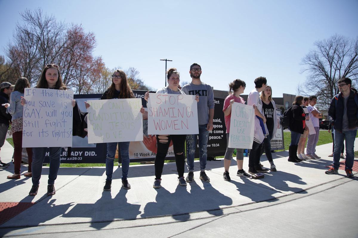 A student-led counterprotest began shortly after CBR came to campus. Students blocked the signs with graphic images by standing in front of them, displaying signs of their own. Photo by John David Clark, Photography Editor