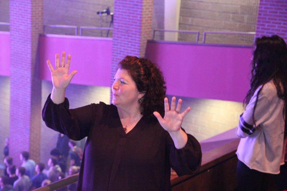 Dr. La-Juan Bradford uses Signed English to translate chapel services in the balcony of the Conn Center. She uses her lips to mouth her words and her hands to sign the messages of the speaker. Photo by Billie Burns