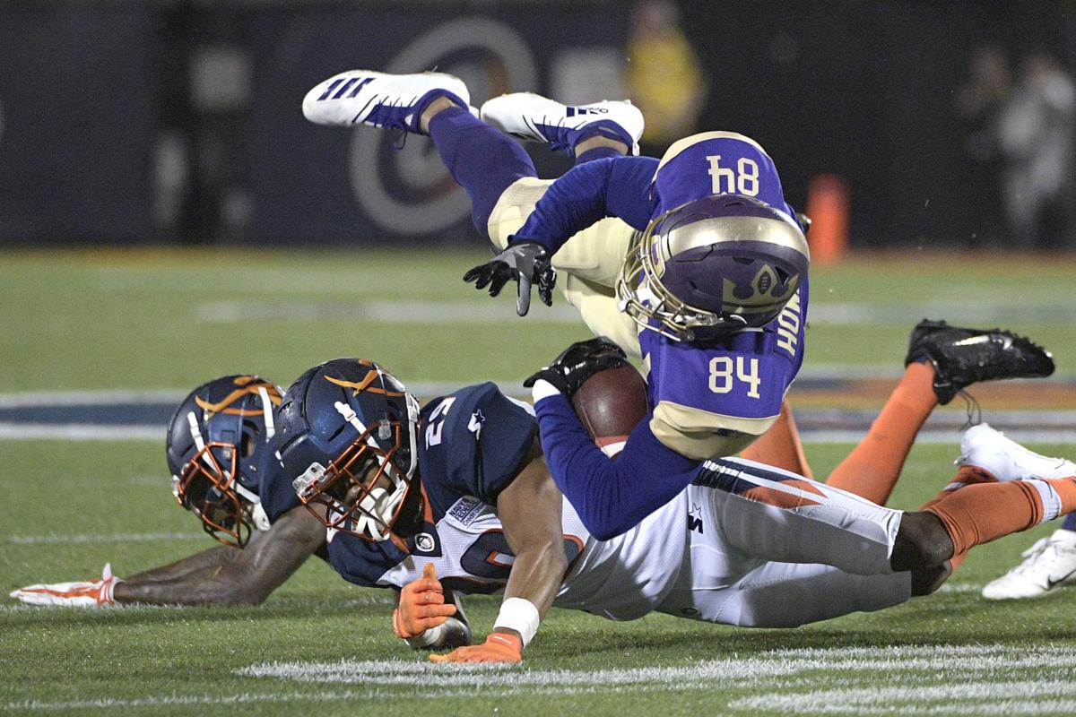 FILE - In this Feb. 9, 2019, file photo, Atlanta Legends receiver Bug Howard (84) is tackled by Orlando Apollos safety Will Hill and defensive back Keith Reaser (29) after catching a pass during the first half of an Alliance of American Football game, in Orlando, Fla. AP Photo/Phelan M. Ebenhack