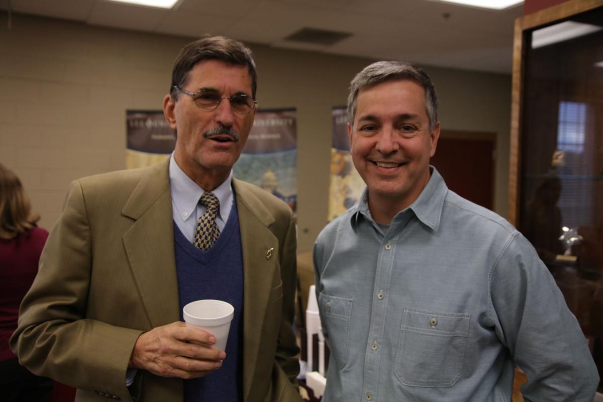 President Paul Conn (left) and Dr. John Coats (right) at Bledsoe's book premiere and reception. Photo by John David Clark