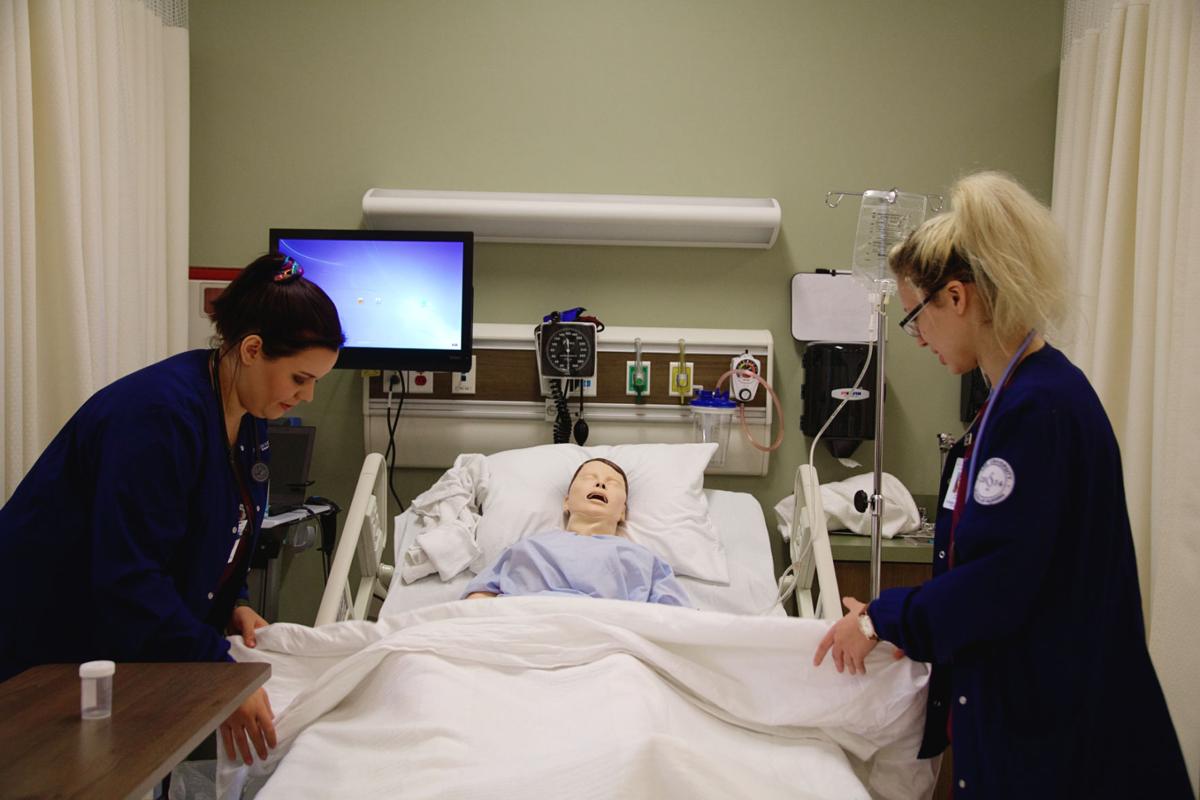 Sophomore nursing students demonstrate proper patient care. Photo by John David Clark