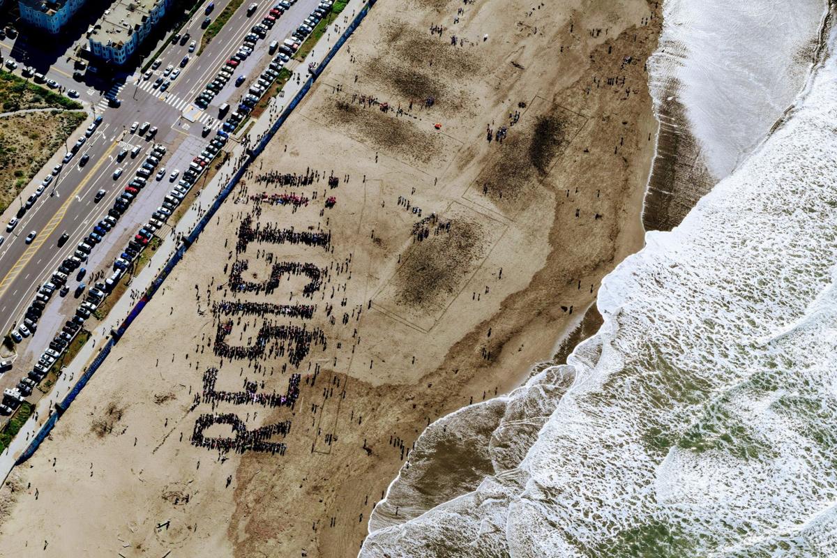 Angry protesters gather in formation on a San Fransisco beach following Donald Trump's election. Courtesy of Tim Gouw