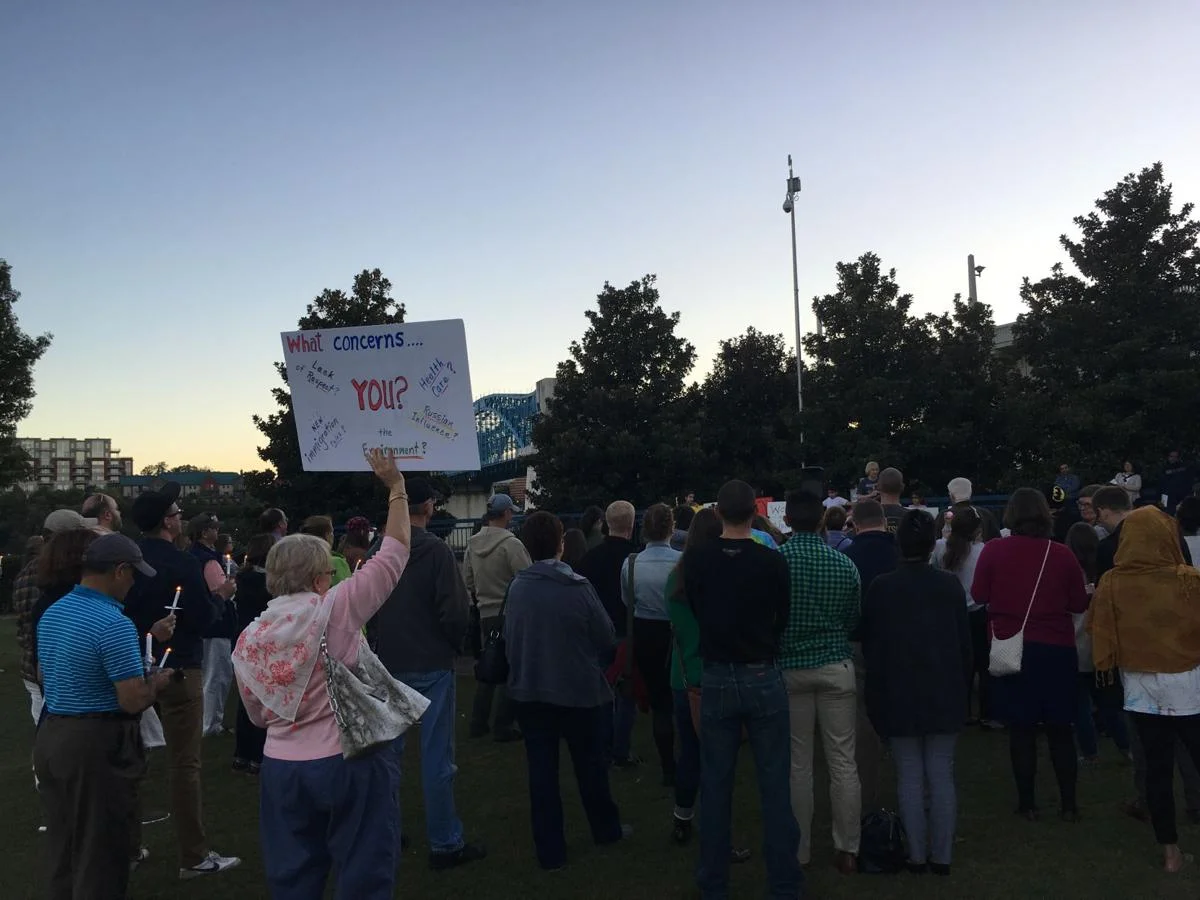 Attendees hold signs at the candlelight vigil in Chattanooga's Coolidge Park. Courtesy of Karina Radionova