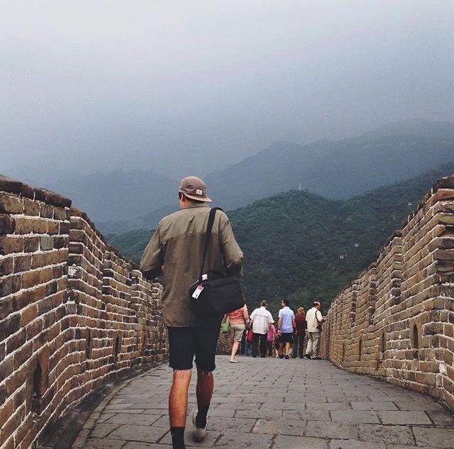 John walks the Great Wall of China, camera bag in tow. Courtesy of John Bentley