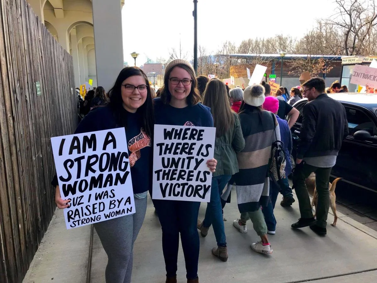 Lee students Kaitlyn Anderson and Amanda Akin hold up their signs of protest at the Women's March in Chattanooga. Courtesy of Kaitlyn Anderson