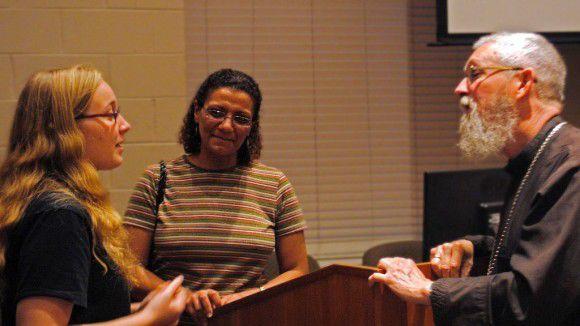 Father Freeman speaking with students following his lecture. (Photo By Austin Gunter)