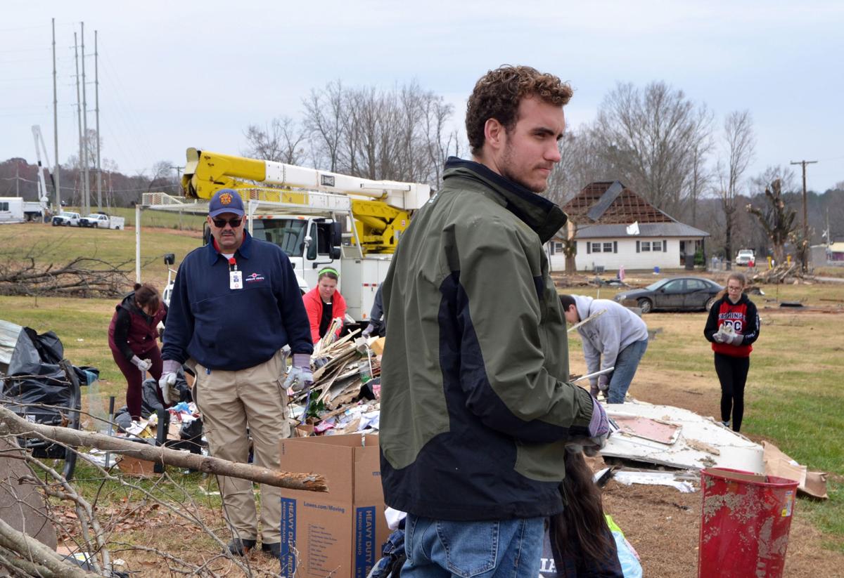 Tatum McKinnon (front) helps clean up tornado damage alongside fellow students and Campus Pastor Jimmy Harper (left) in Polk County, TN on Saturday, Dec. 3. Photos by Kimberly Sebring