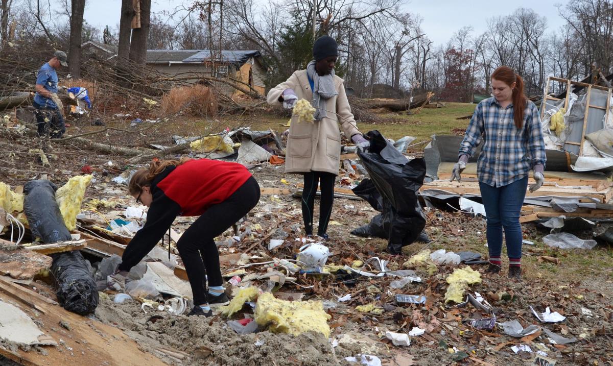 Students (from left) Amelia Wilson, Yinka Adedayo and Cassidy Gray help clean up tornado debris on Saturday, Dec. 3.