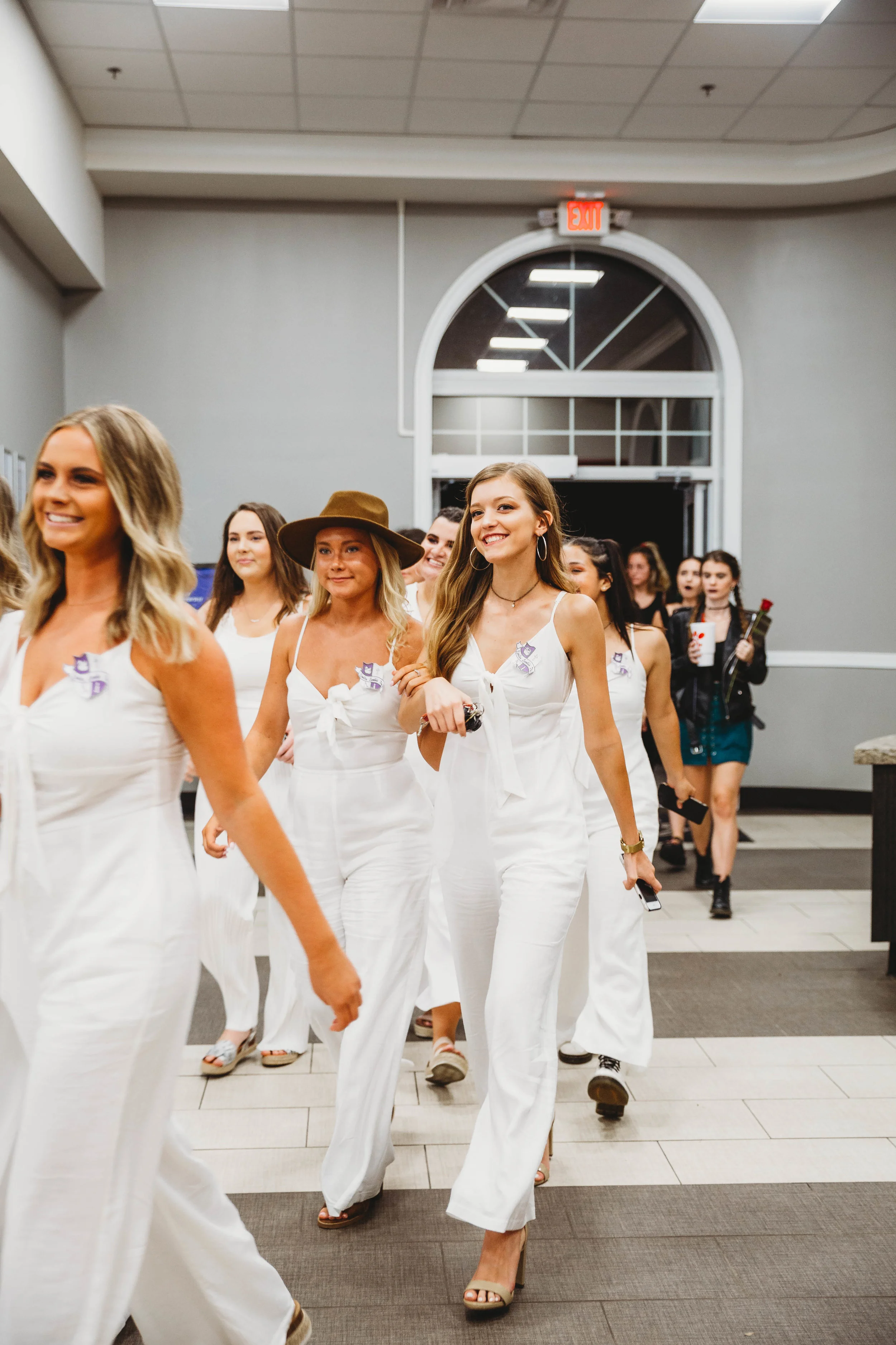 Epsilon Lambda Phi makes their entrance into the cafeteria, with new members following.