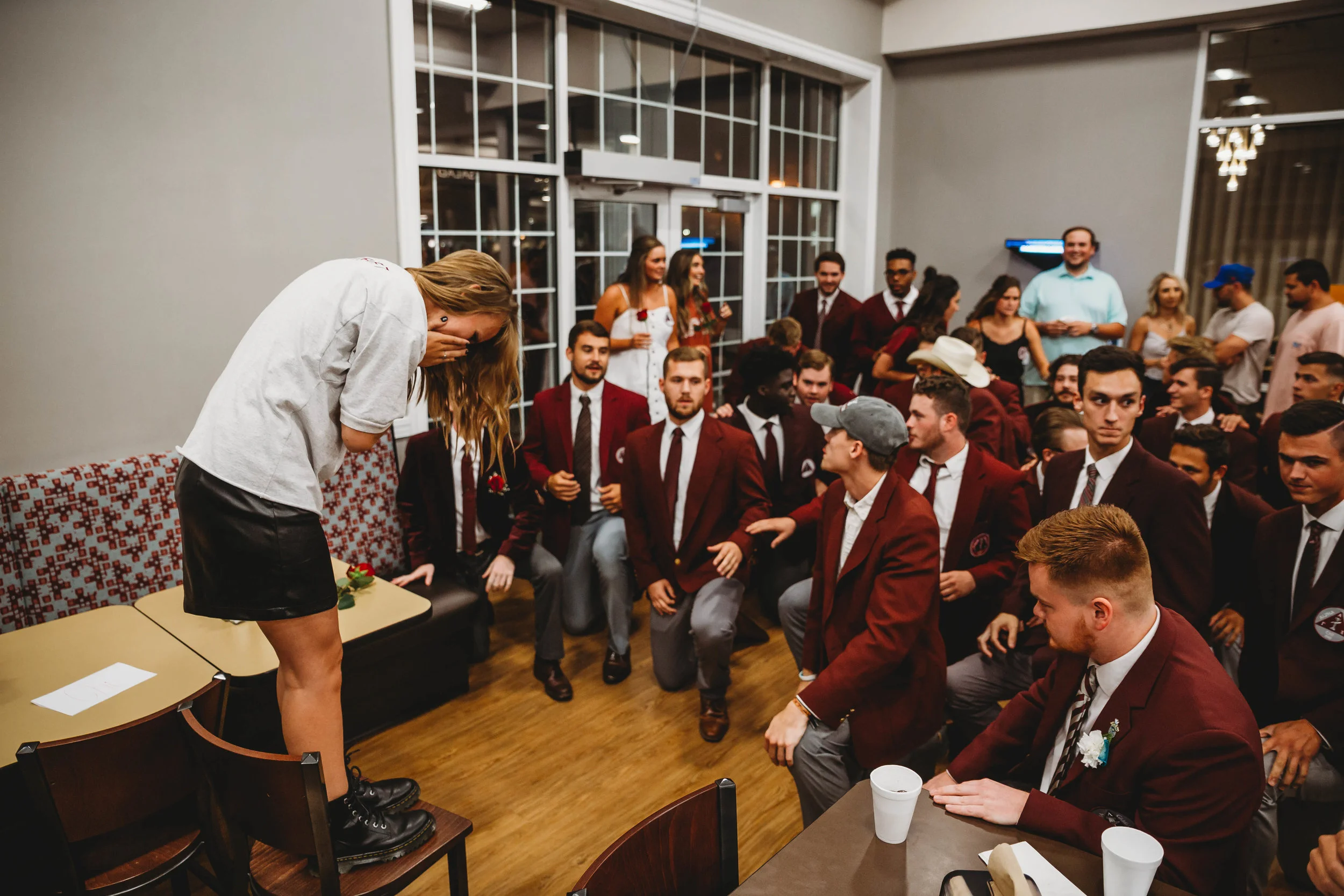 Alpha Gamma Chi members kneel for their new sweetheart.