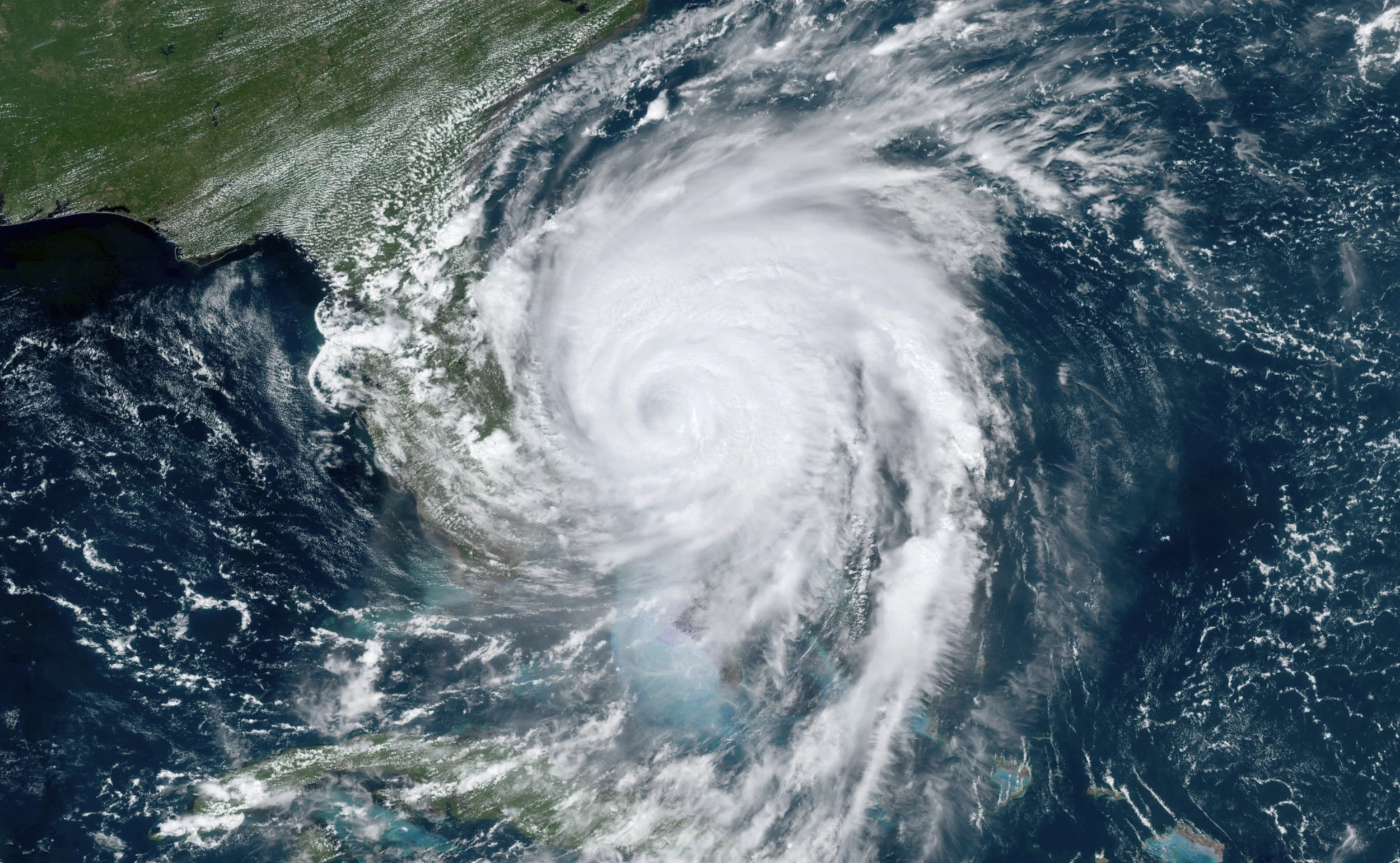 This GOES-16, GeoColor satellite image taken Tuesday, Sept. 3, 2019, at 17:10 UTC and provided by National Oceanic and Atmospheric Administration (NOAA), shows Hurricane Dorian moving off the east coast of Florida in the Atlantic Ocean. (NOAA via AP)