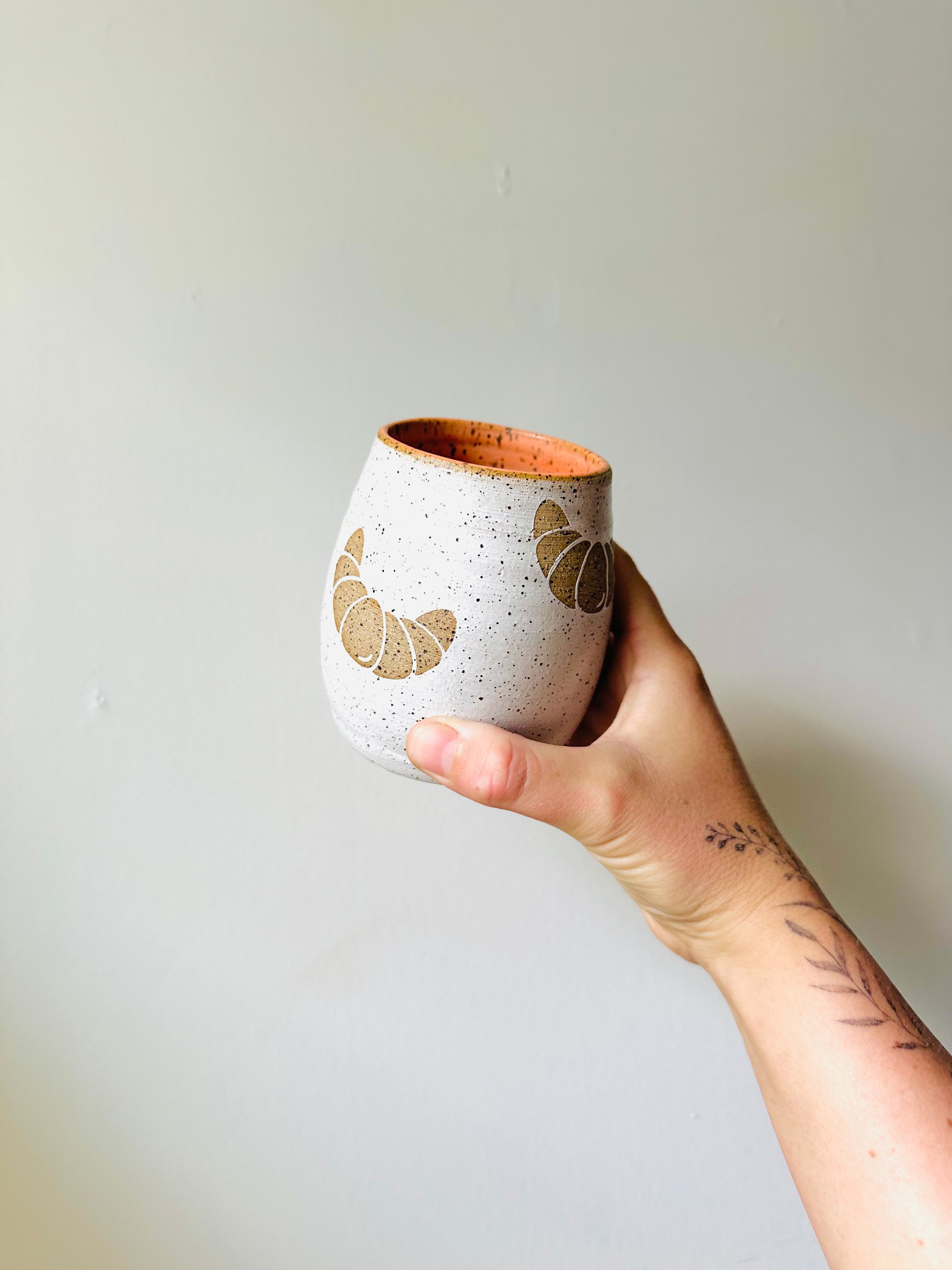 Holding-View-of-Handmade-Tumbler-with-Croissants-on-it.jpg