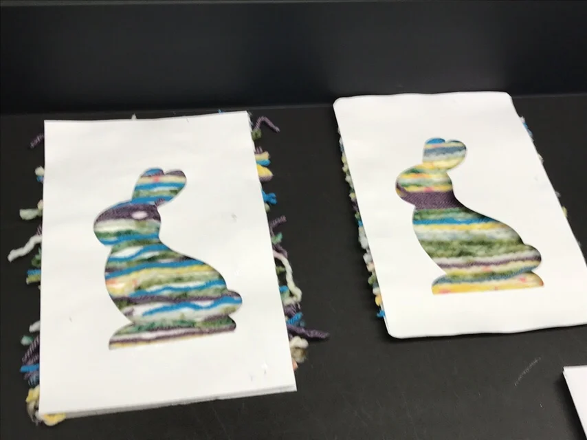 This was the other project. We glued yarn pieces to a background and then attached the cutout over. This was a huge hit! Most of the students made multiples. This was also a good project to practice cutting, following directions and color placement.