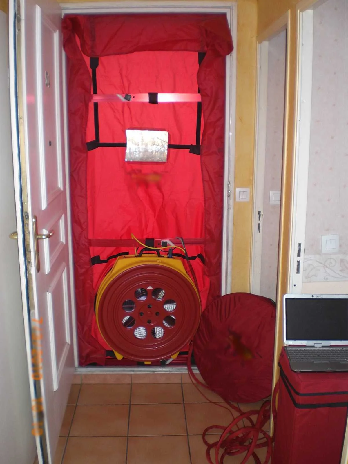 A blower door test measures a building's air tightness by measuring air
