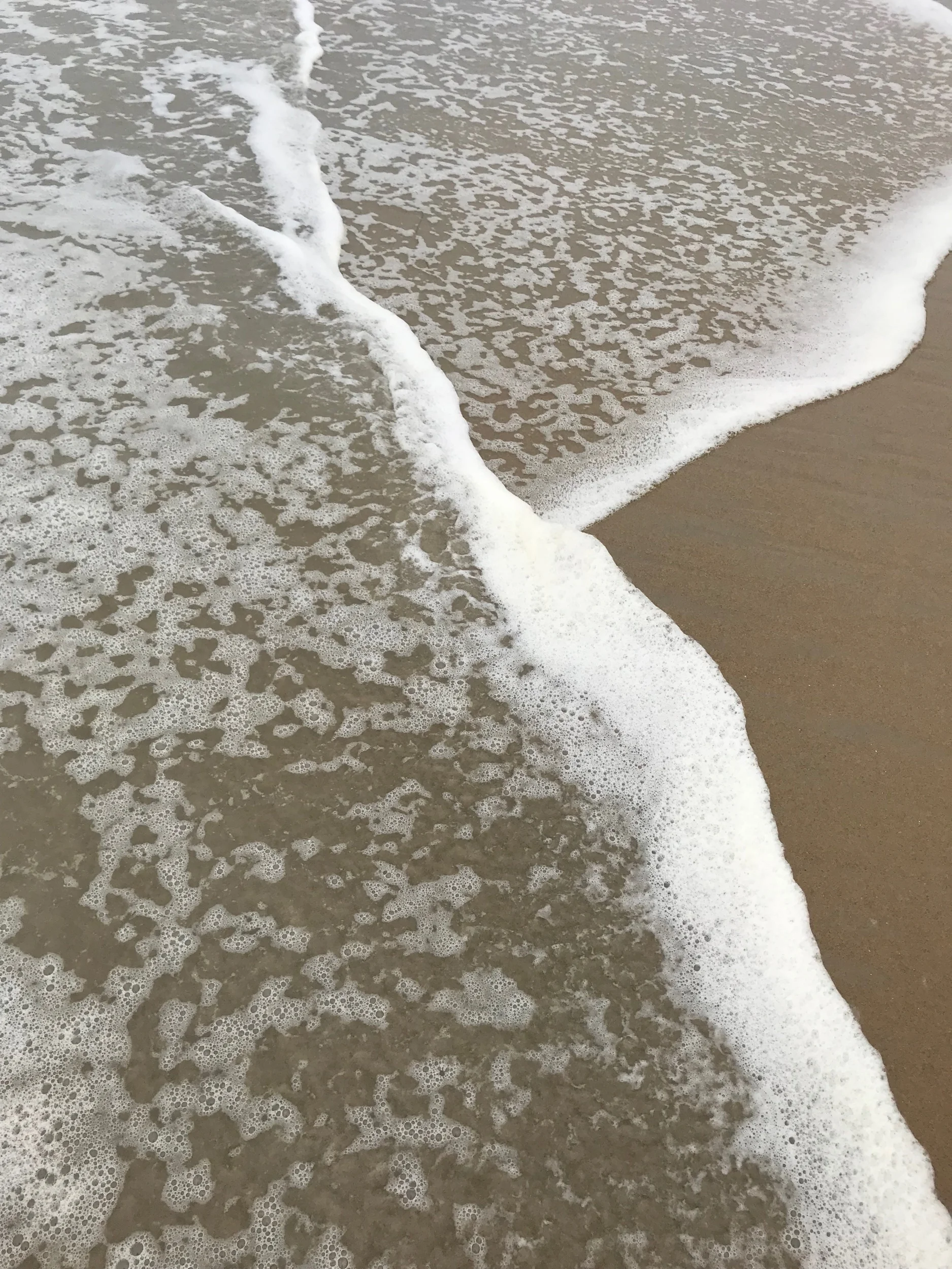The water drifting onto the shore.