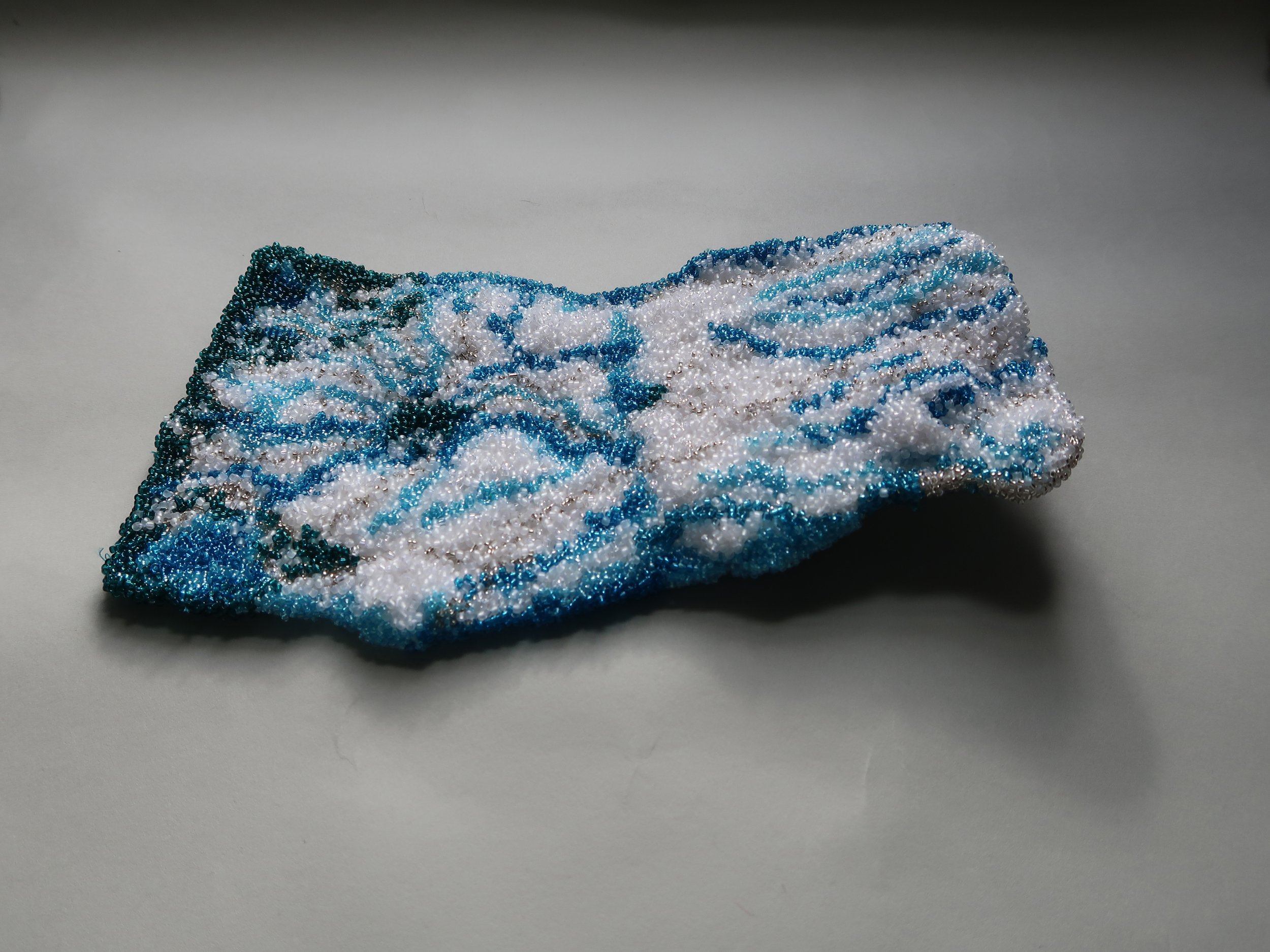 untitled (grounding lines) , 2024-2025, Glass, Thread, Plastic, Recycled Sterile Surgical Pads, .875 × 9.5 × 5.75”