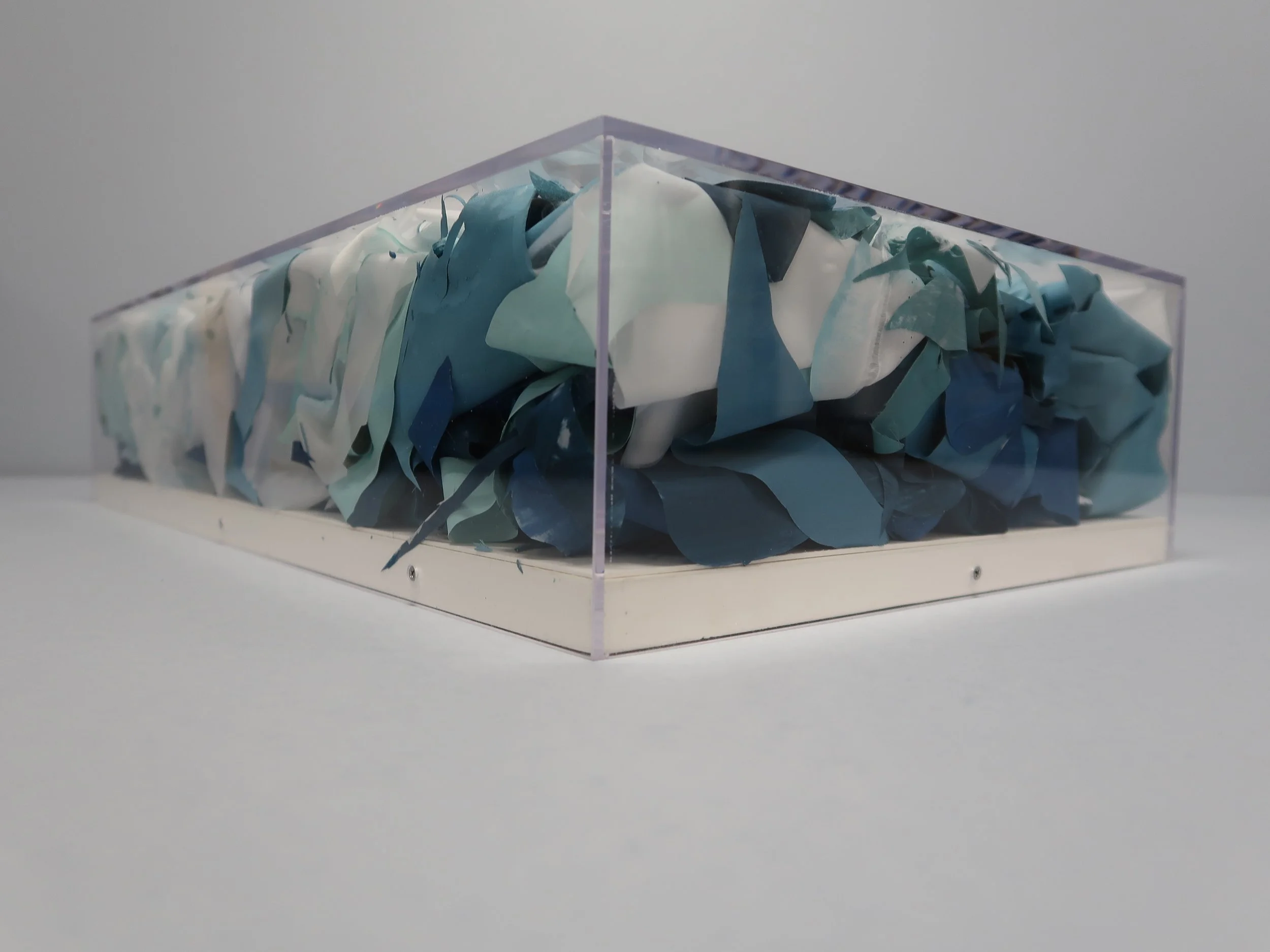 untitled (stamukhi I) , 2025, Recycled Plexiglass Vitrine, Recycled Film Projection Screen, Recycled Interior House Paint, 5.5 × 24.5 × 14”