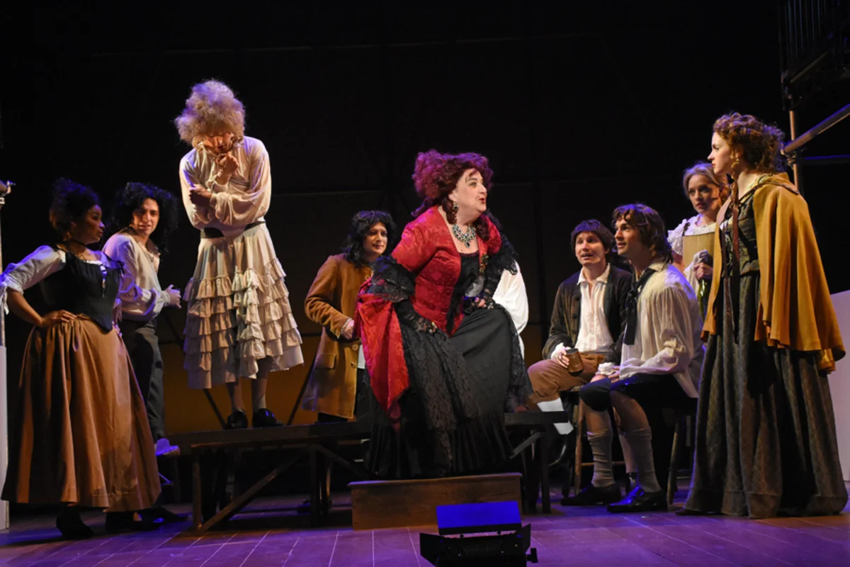 Mistress Revels (J. Shaulis) confronts Margaret Hughes (M. Höglund) at the tavern as revelers look on - Photo by Tina Buckman