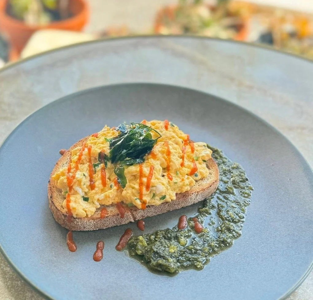 Chilli Oil Scramble
Our talented chefs have created this taste sensation for this weekends special! Fluffy scrambled eggs drizzled with house-made chilli oil, topped with crispy fried parsley and a generous sprinkle of parmesan. A perfect balance of 