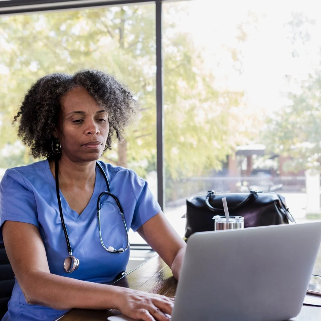 Assured Healthcare Staffing nurse at computer ready to help staff with technology