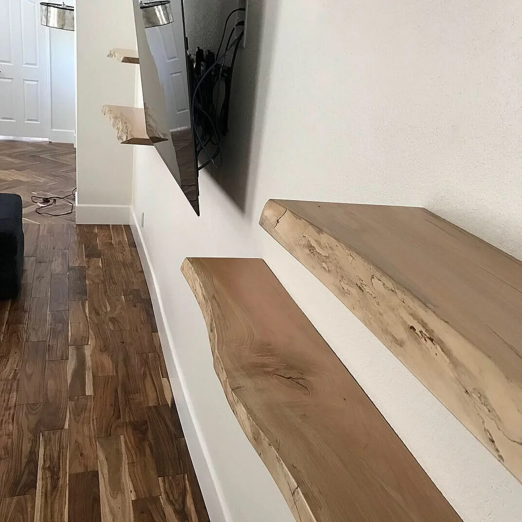 Wood shelves fitted beside a wall-mounted television