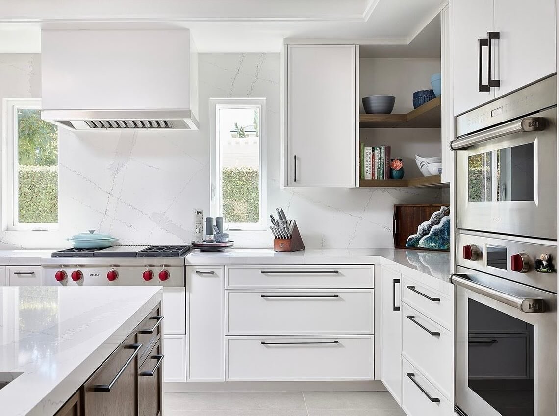 White kitchen cabinetry around the range and built-in appliances