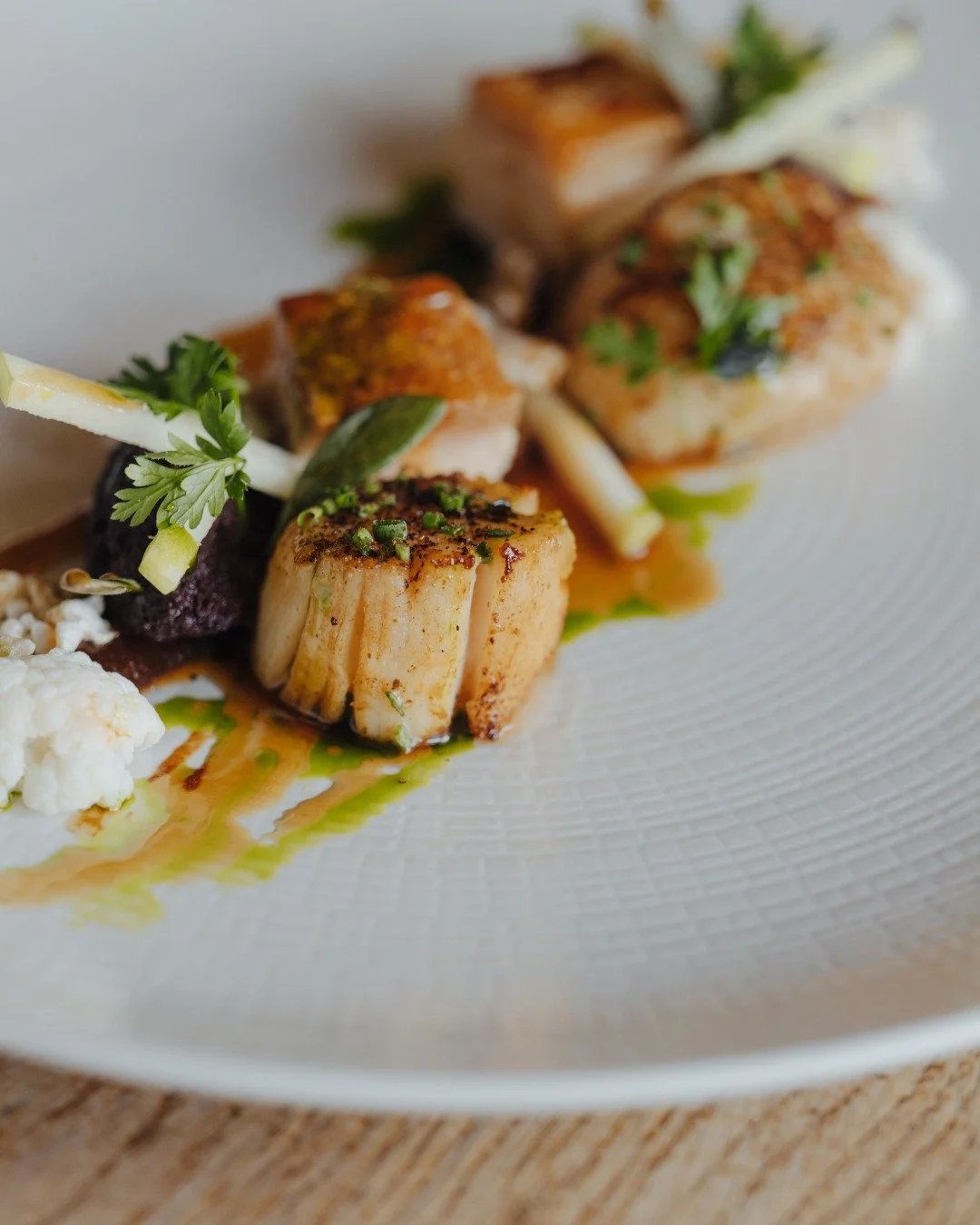 Pan Seared Scallops, Pork Belly, Boudin Noir, Pickled Cauliflower, Granny Smith Apple, Burnt Apple Pur&eacute;e Pork Puff 

View  Sample Menus
https://www.thewildebeest.co.uk/about-our-food