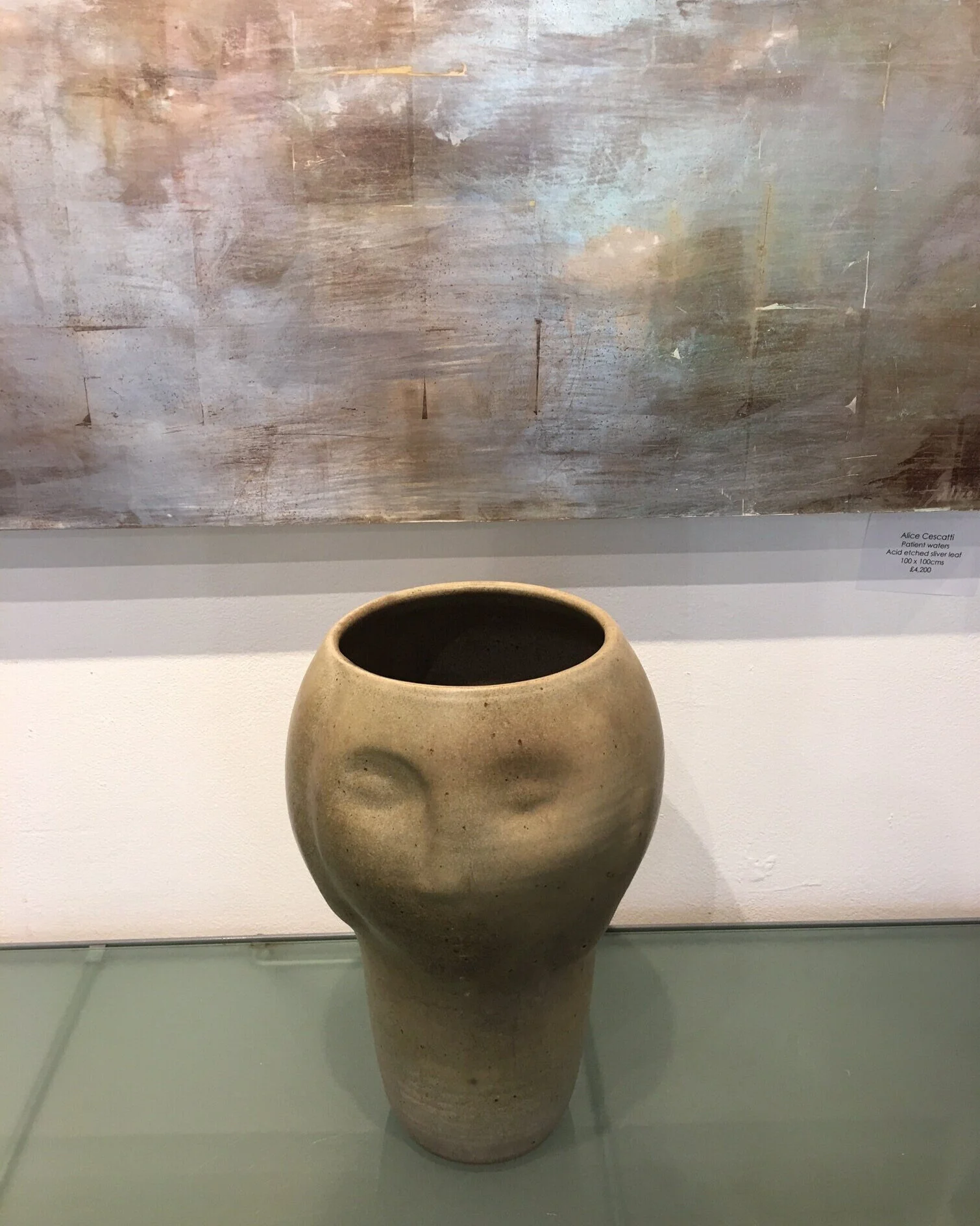 Geoffrey Eastop - Vase form with face with lightly mottled beige glaze.