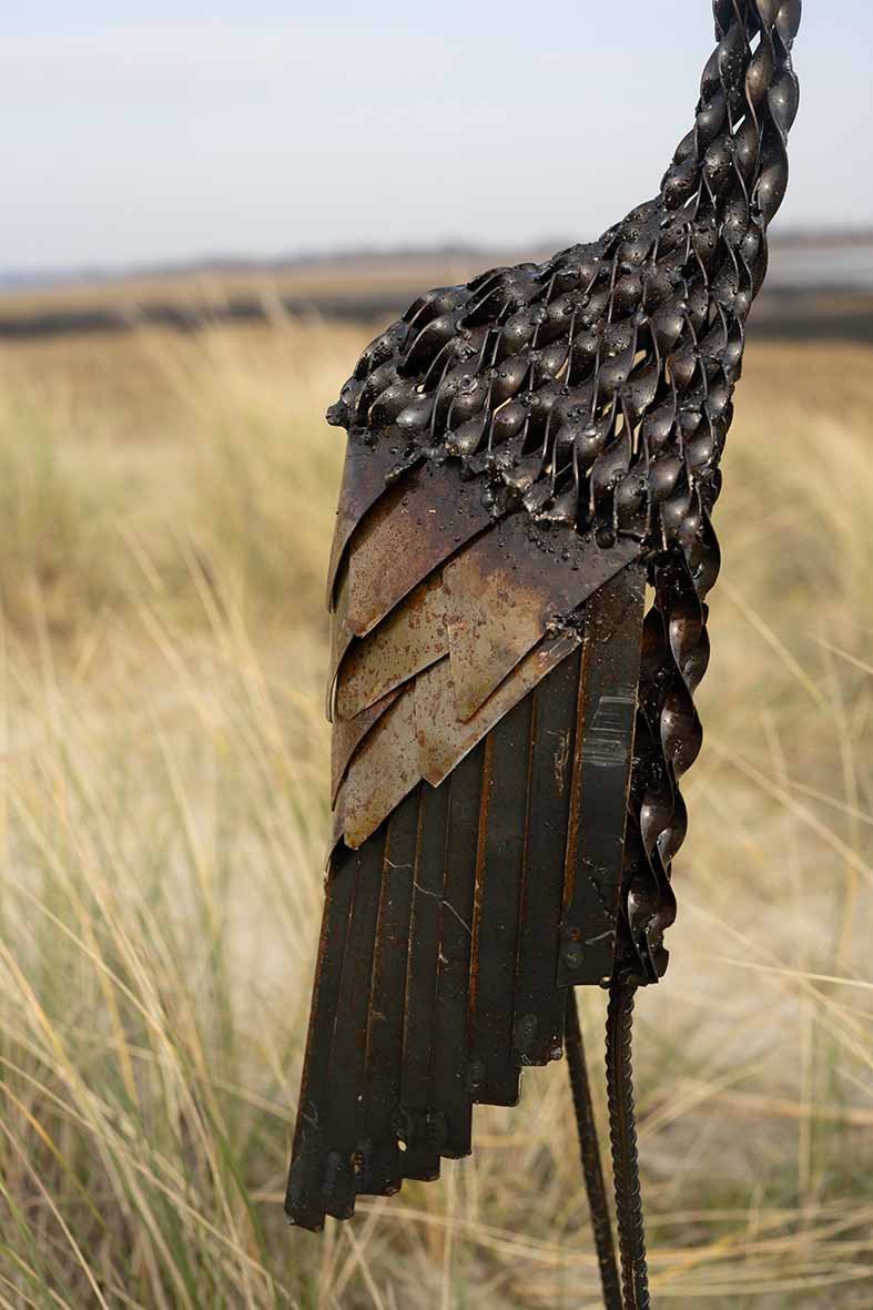 close up of recycled metal crowned crane garden ornament