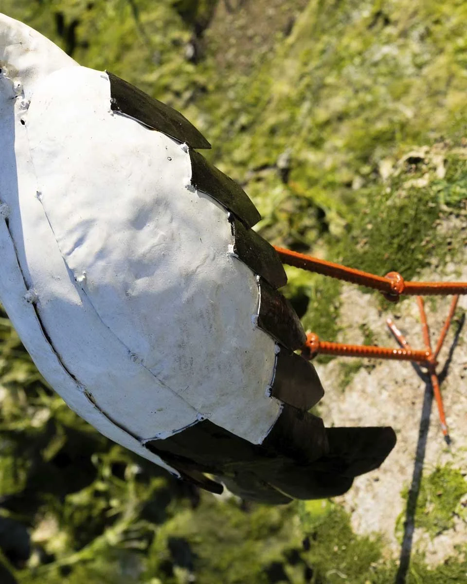 close up of painted stork ornament back detail in white