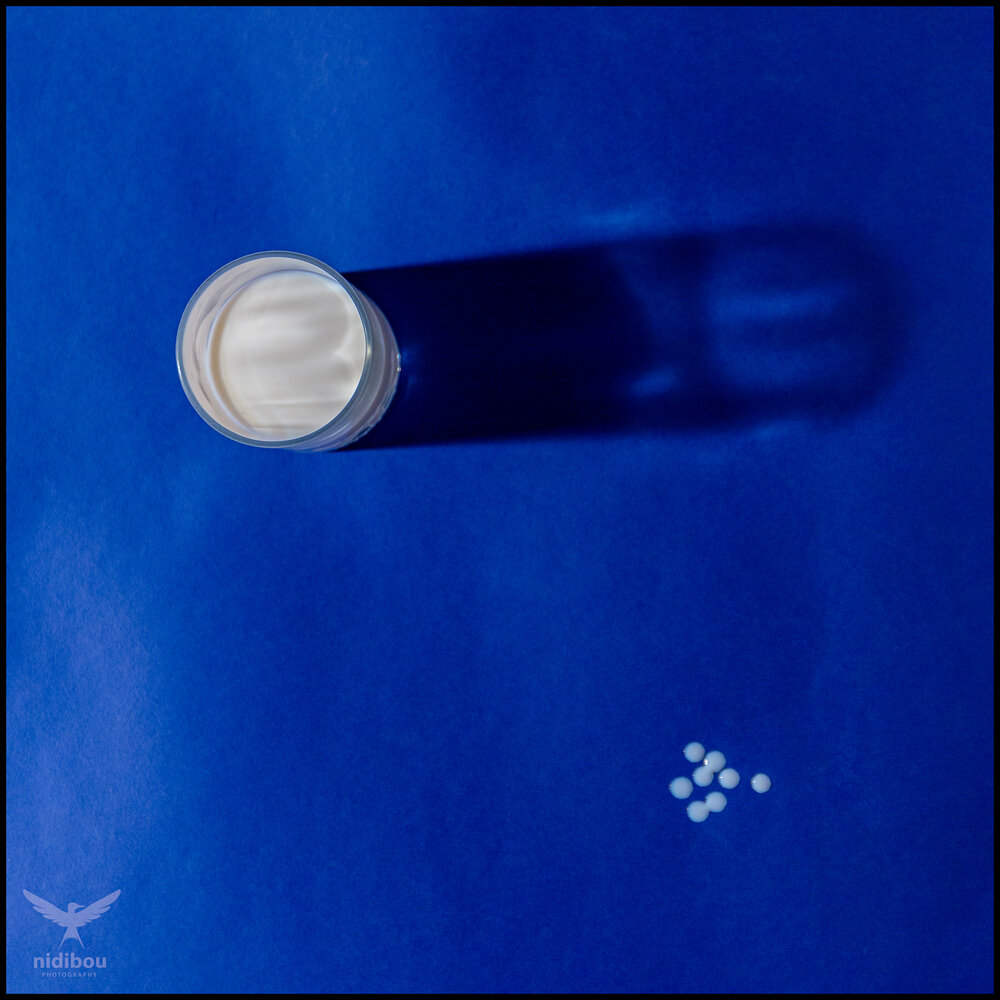 Drops of milk on blue paper