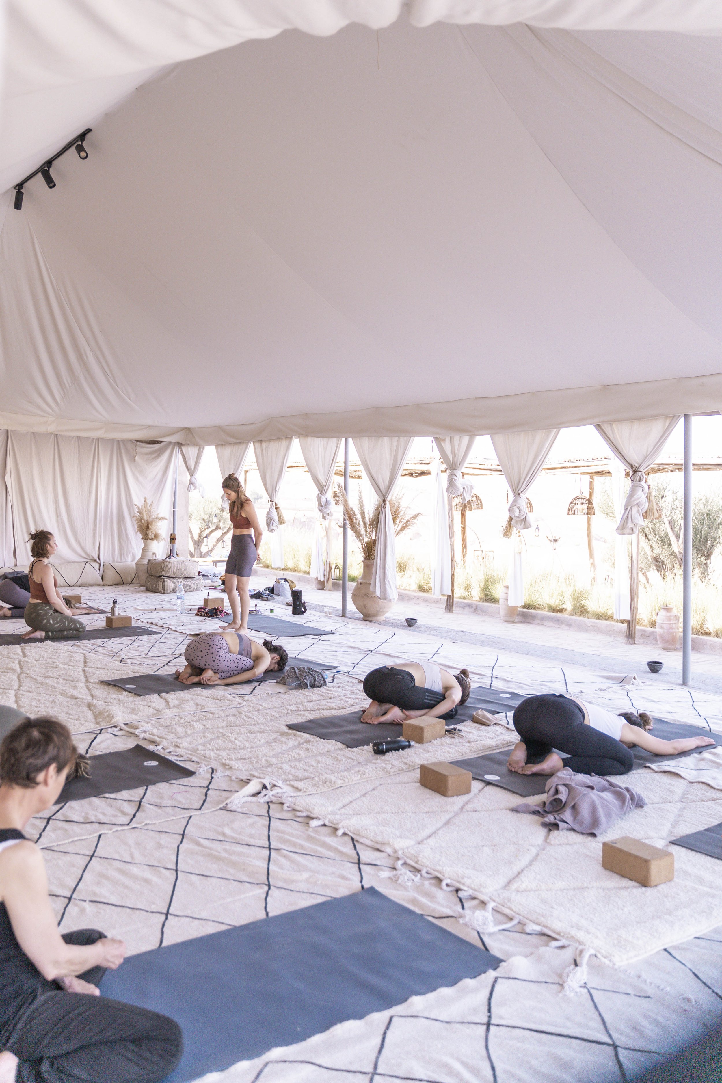 Yogis in childs pose at the INSYNC Club Yoga Retreat in Morocco
