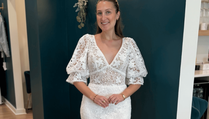 Bride wearing a lace wedding dress with puff sleeves during a bridal appointment at Two Hearts Bridal