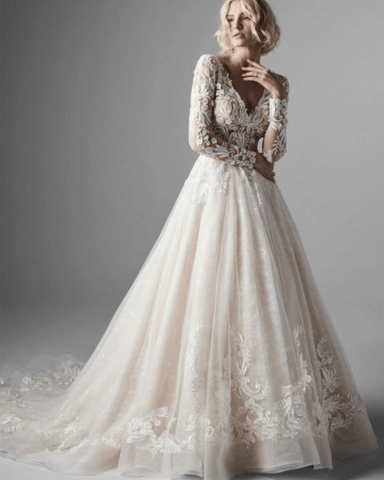 Bride wearing a lace ballgown with long sleeves, perfect example of formal vs semi formal wedding attire for an elegant wedding.