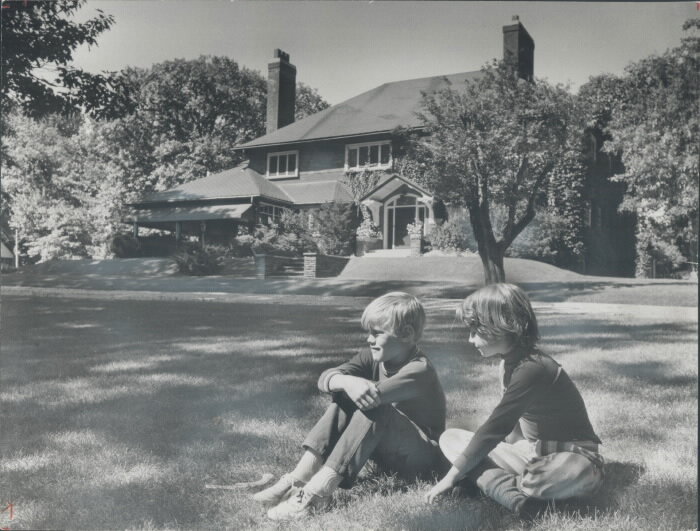 Geoffrey Bonnycastle (8) and Harriet Nell Barnes (7) rest on the lawns before the home of Mrs. F. K. Morrow, Wychwood Park - 1970 (Copy)