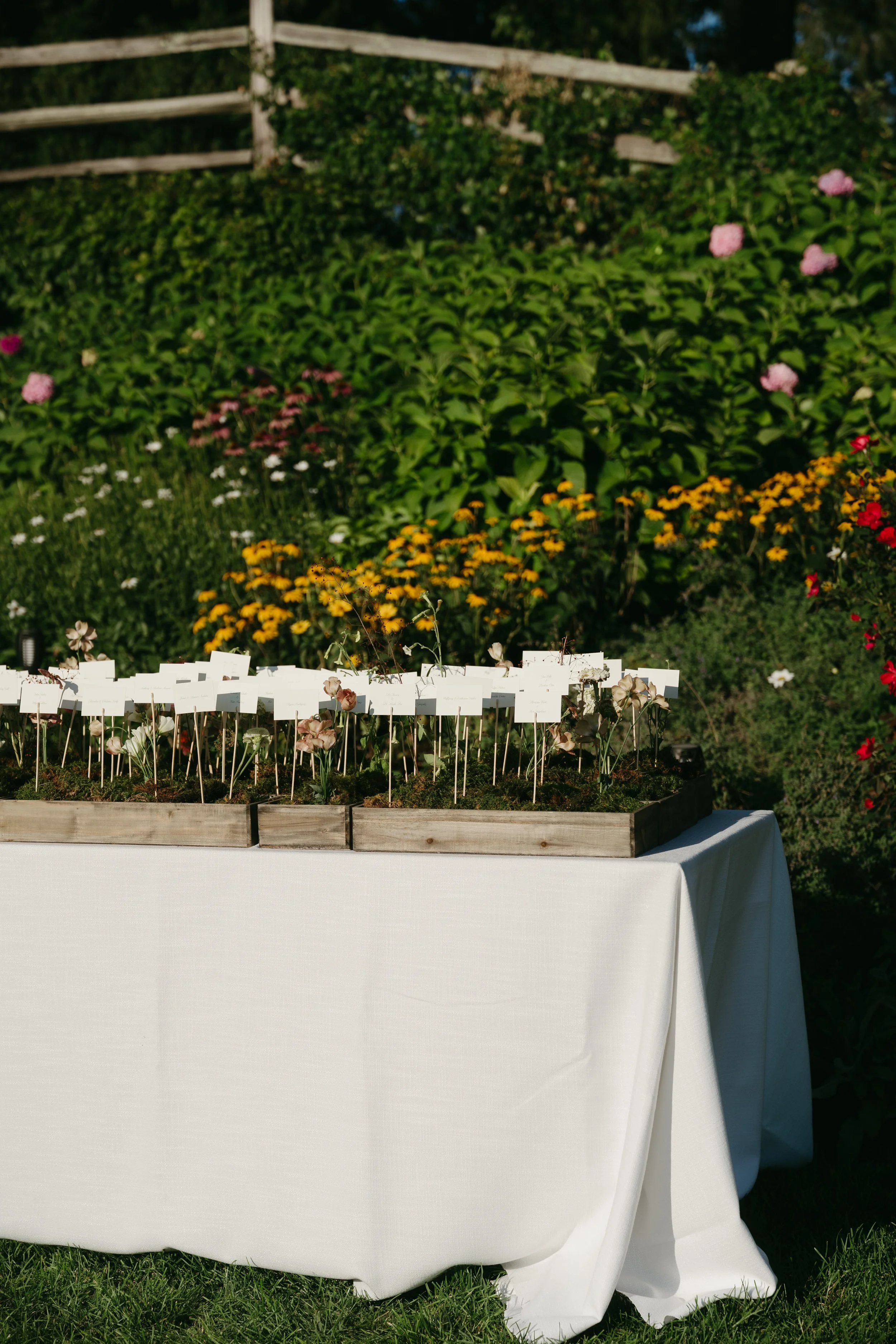 Escort card display accented with delicate floral stems