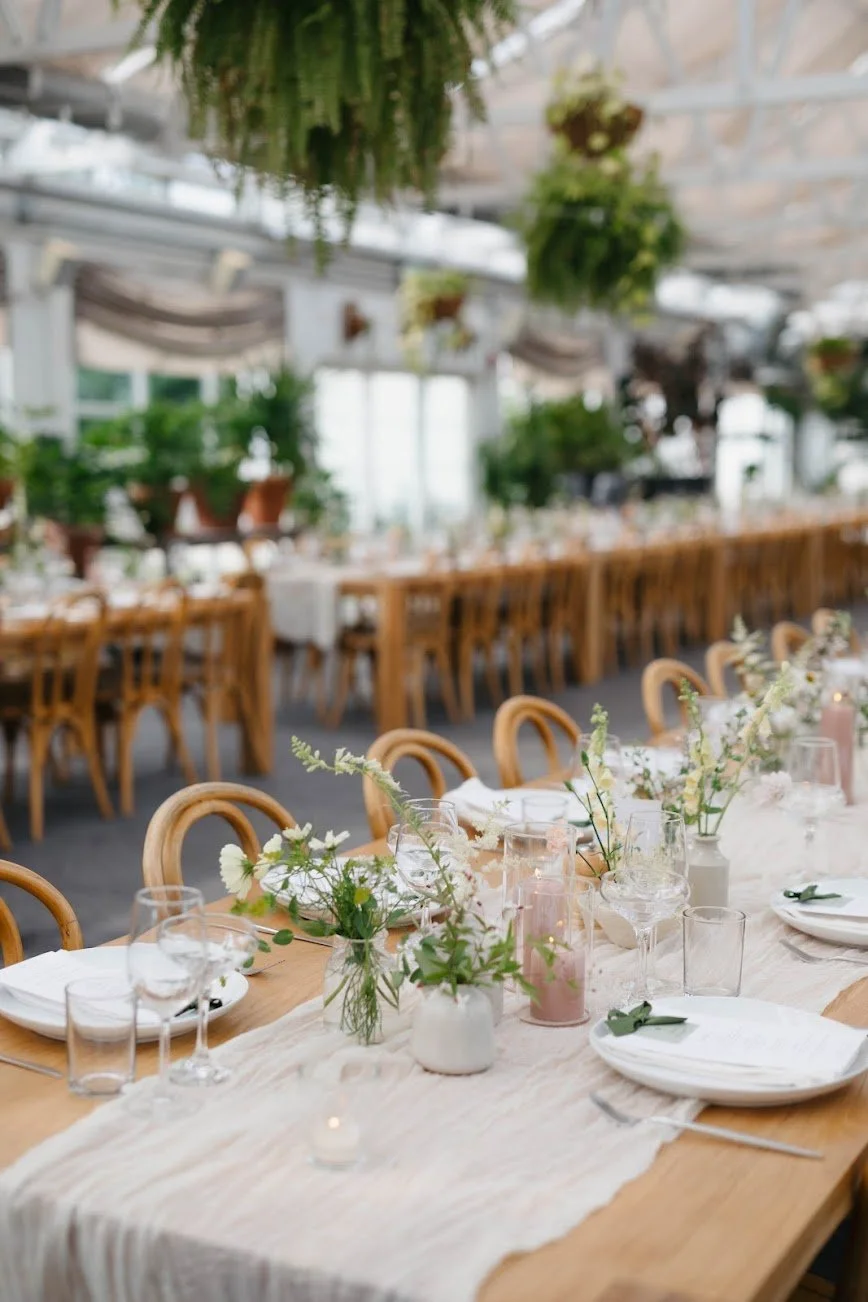  Table composition with sheer fabric down the middle, pink candles and wispy hand tied designs 