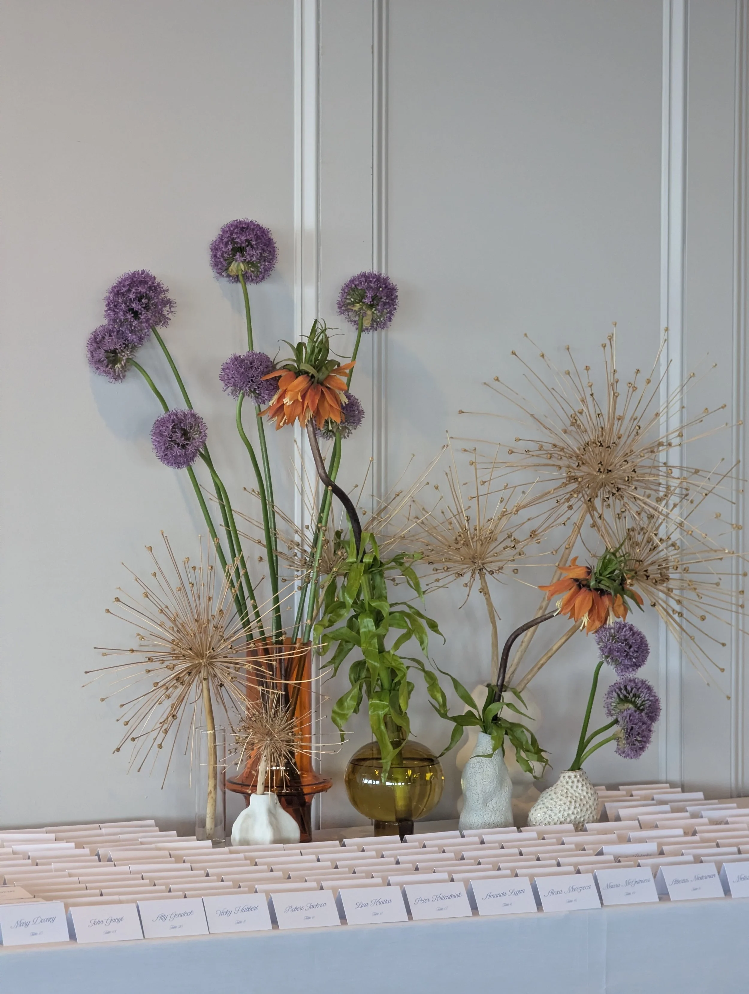  card table decorate with bold and airy allium blooms    