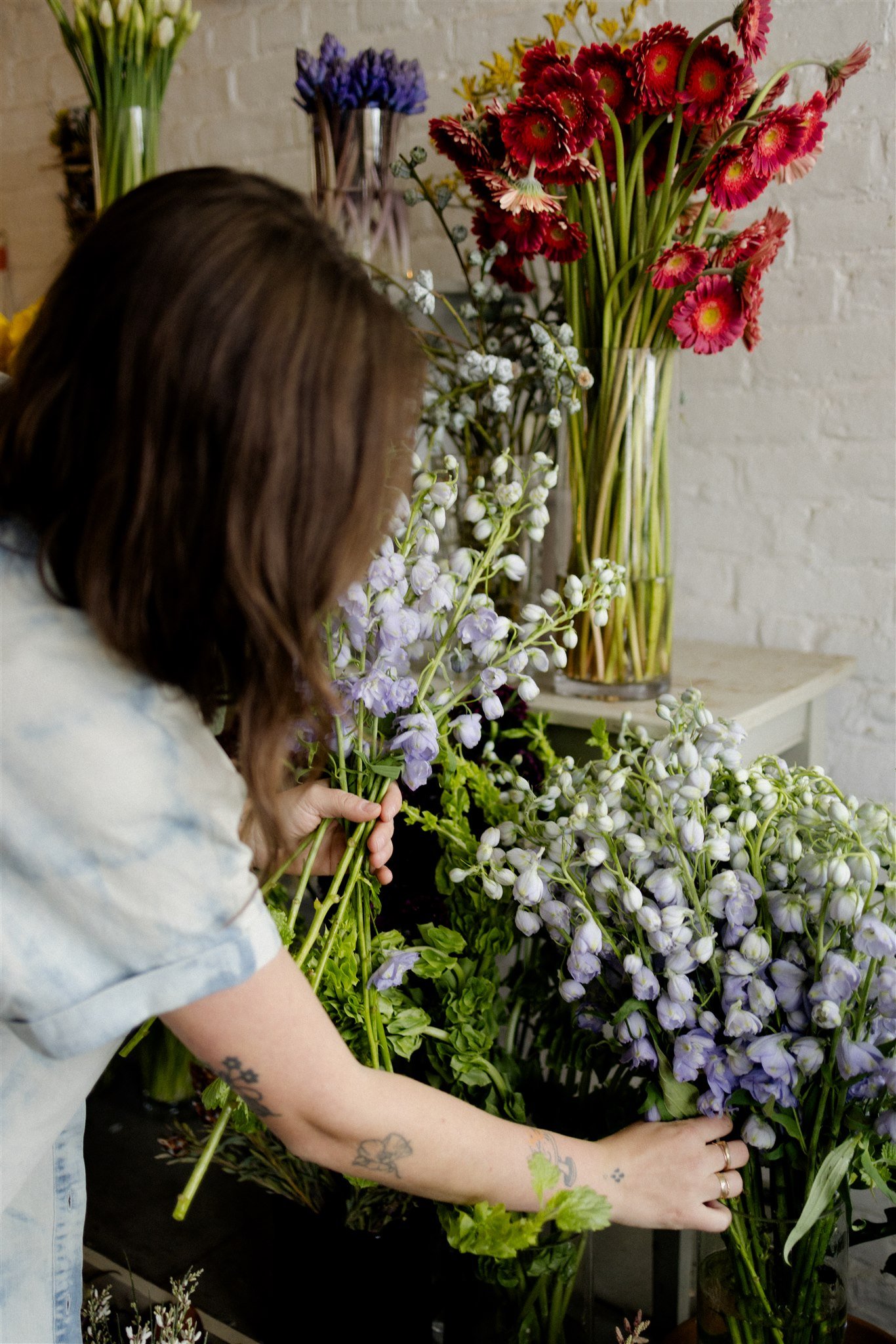  Flower bar being stocked with sustainable, fresh and fluffy larkspurs in Beacon flower shop 