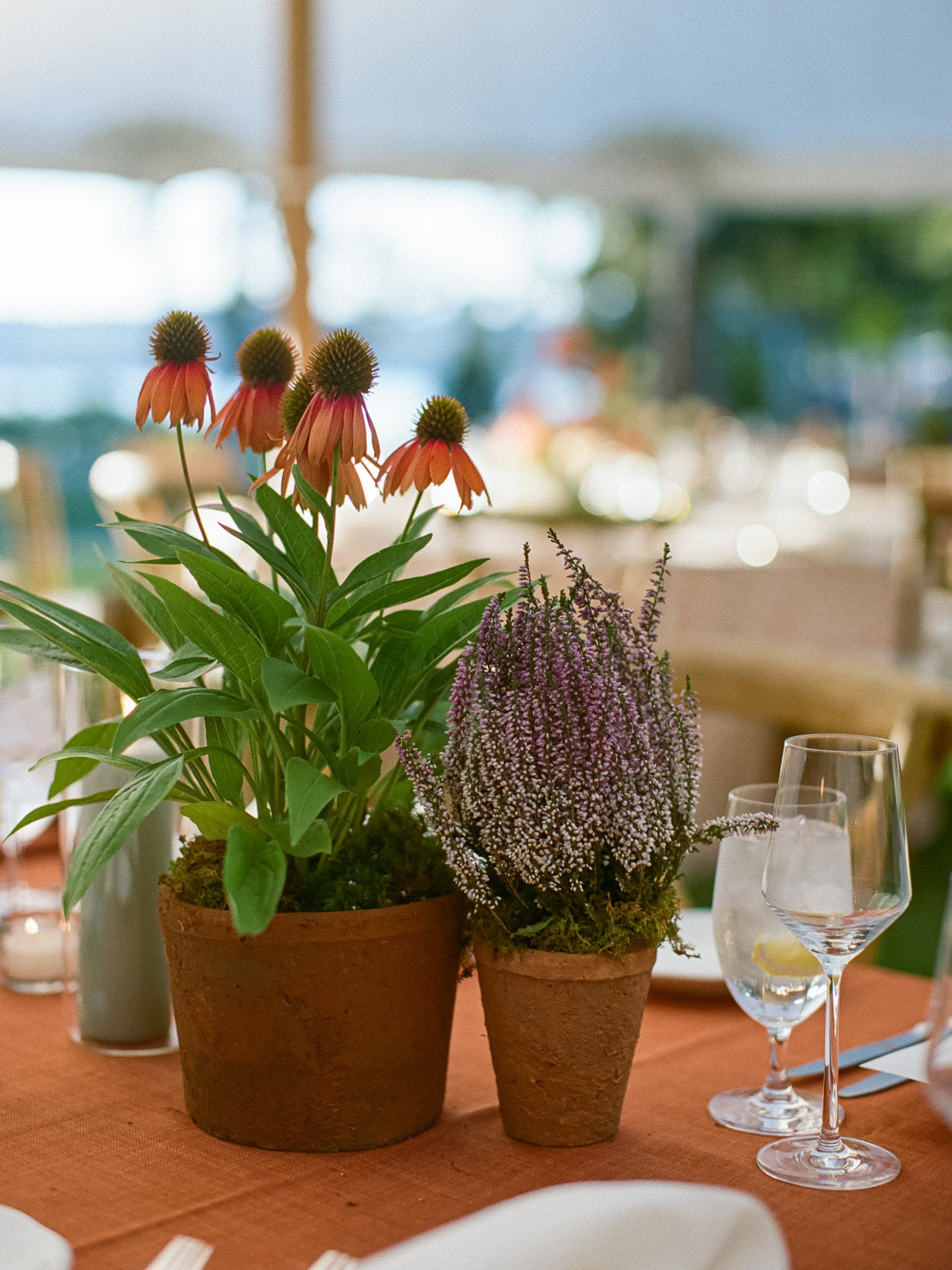  Meadow-inspired reception table with textured flowers in simple ceramic pots 
