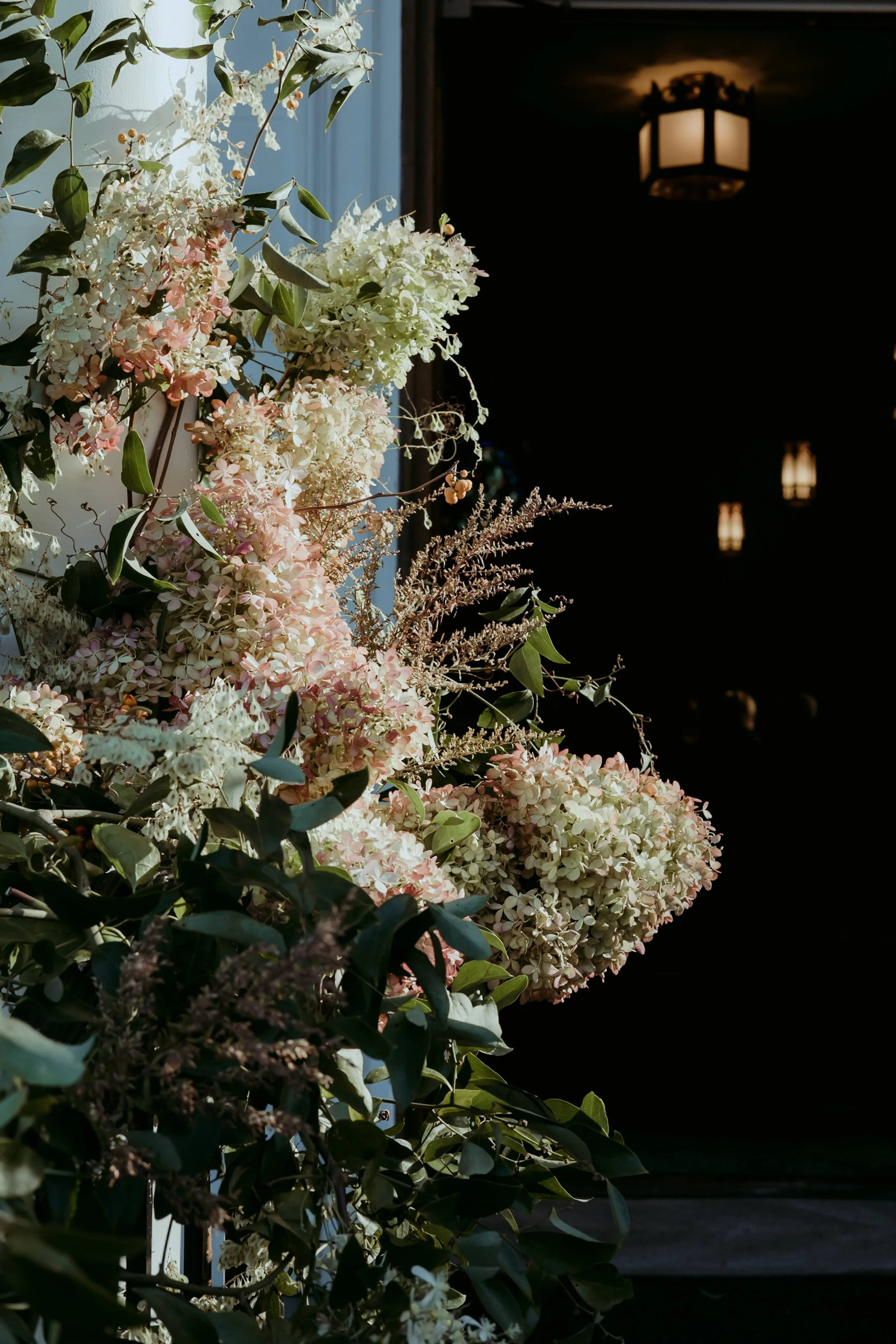  Lush, playful composition creeping along a doorway with airy flowers and robust leaves  