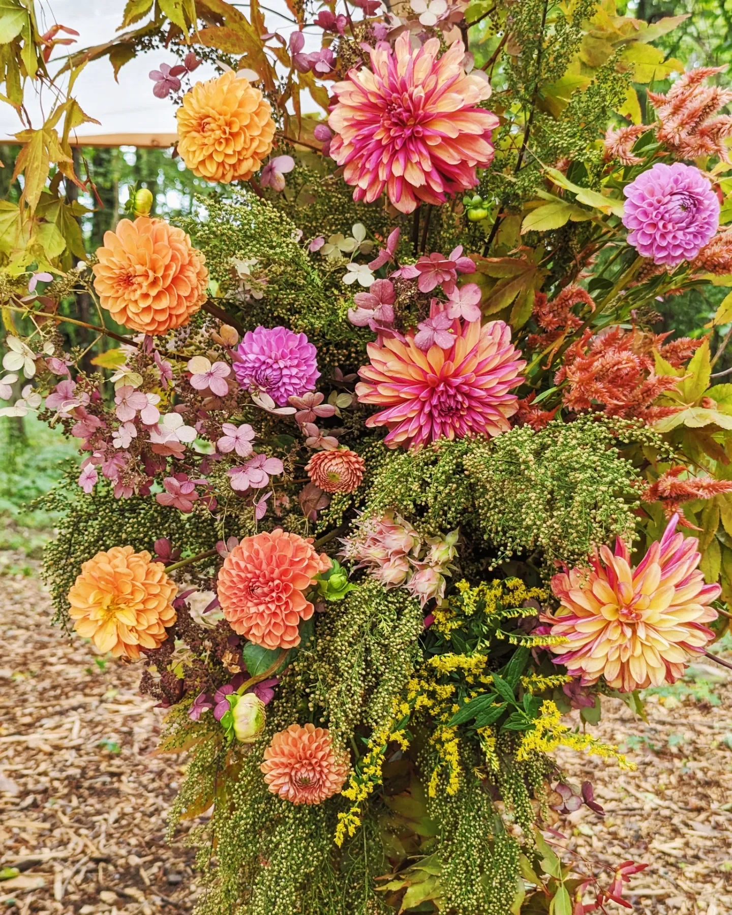  Sculptural arrangement designed with striking and vibrant flora including vivid dahlias 