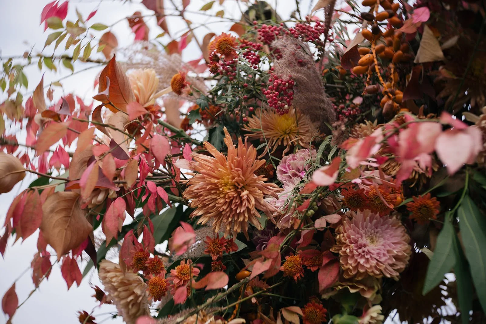 Striking bouquet featuring red foliage and textured florals 