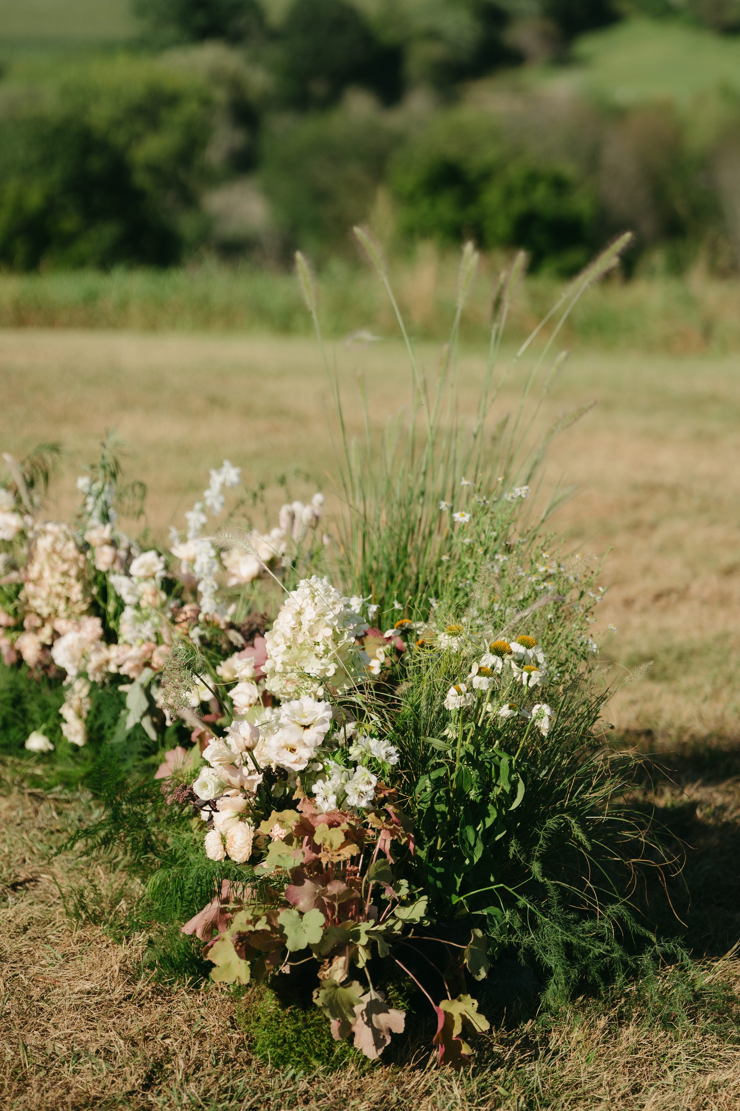 Meadow-style floral arrangement placed at ceremony