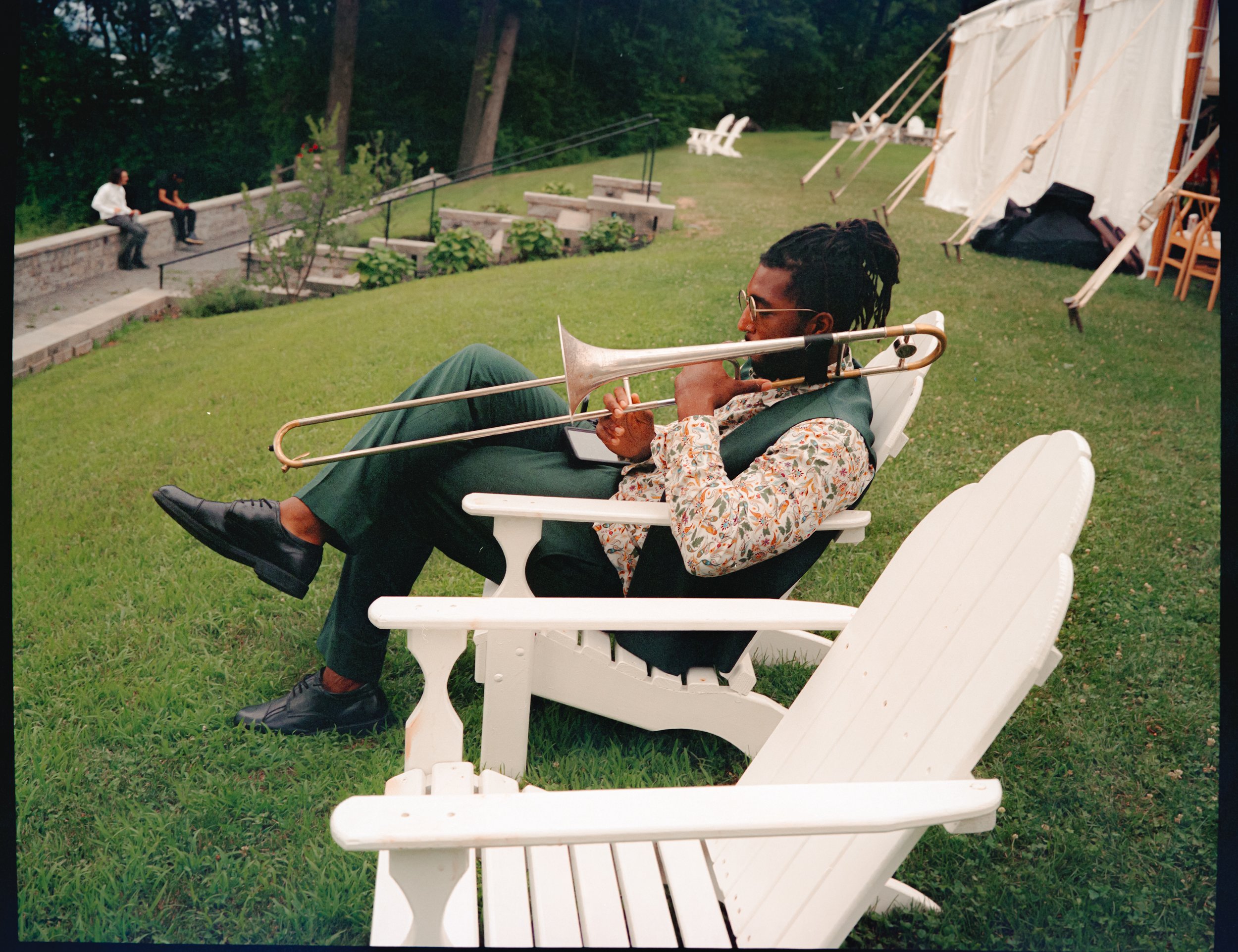 Musician relaxing on lawn chairs during A Private Estate wedding reception